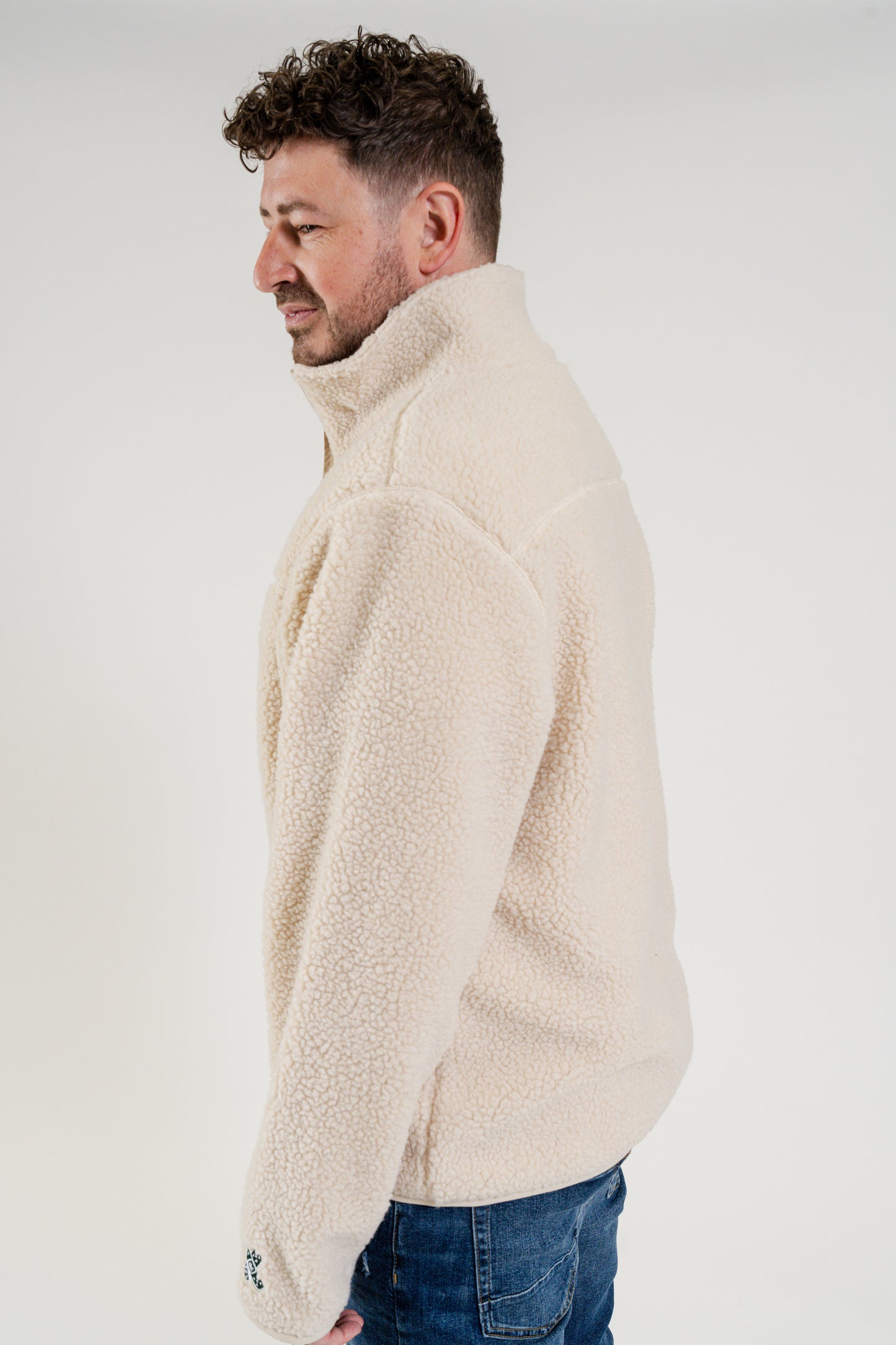 Side view of male model wearing a mens fluffy cozy shepra jacket